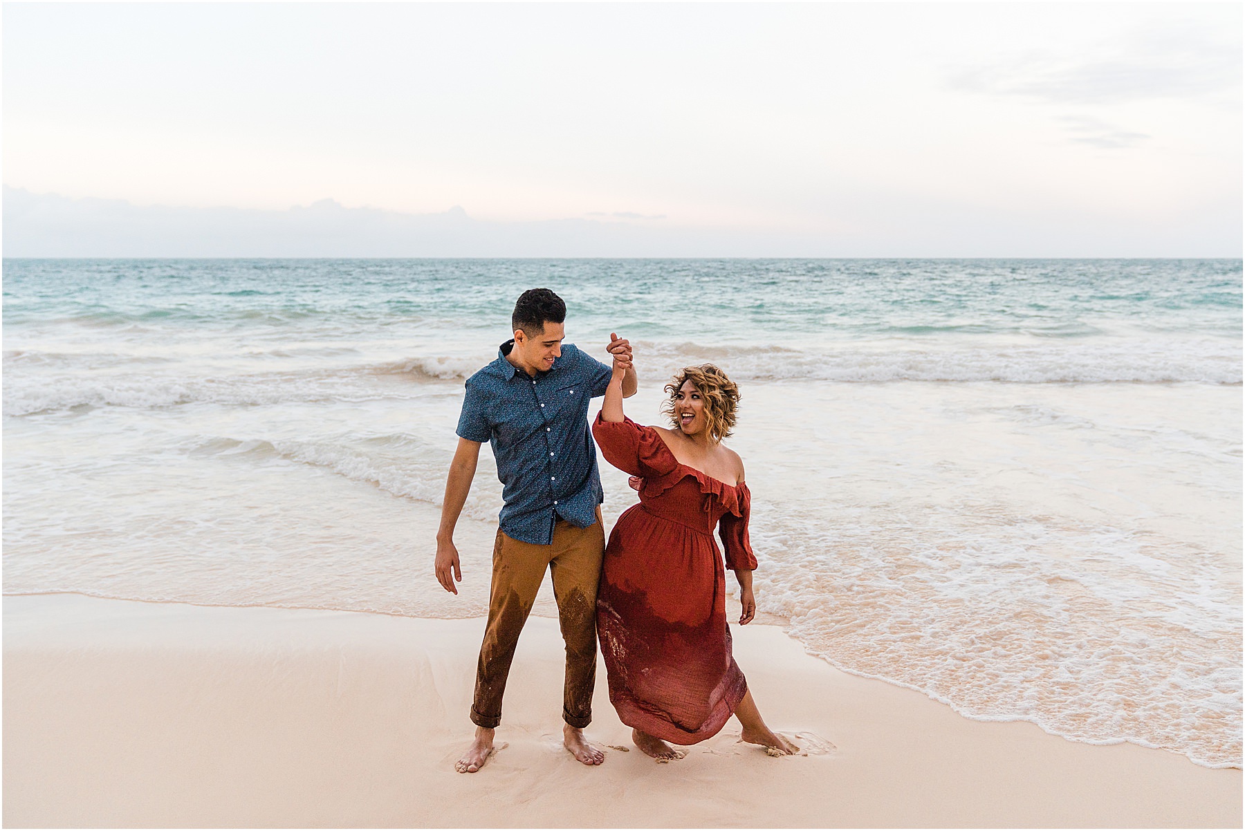 playful couple having fun on beach for anniversary photo session