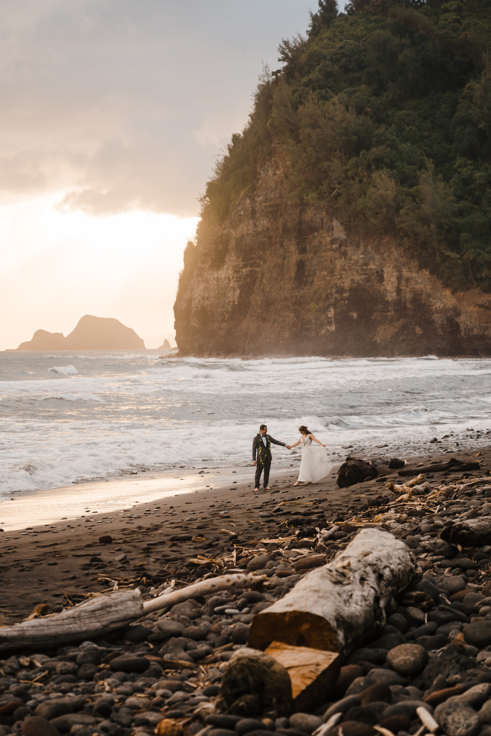 bride and groom eloping on black sand beach in hawaii