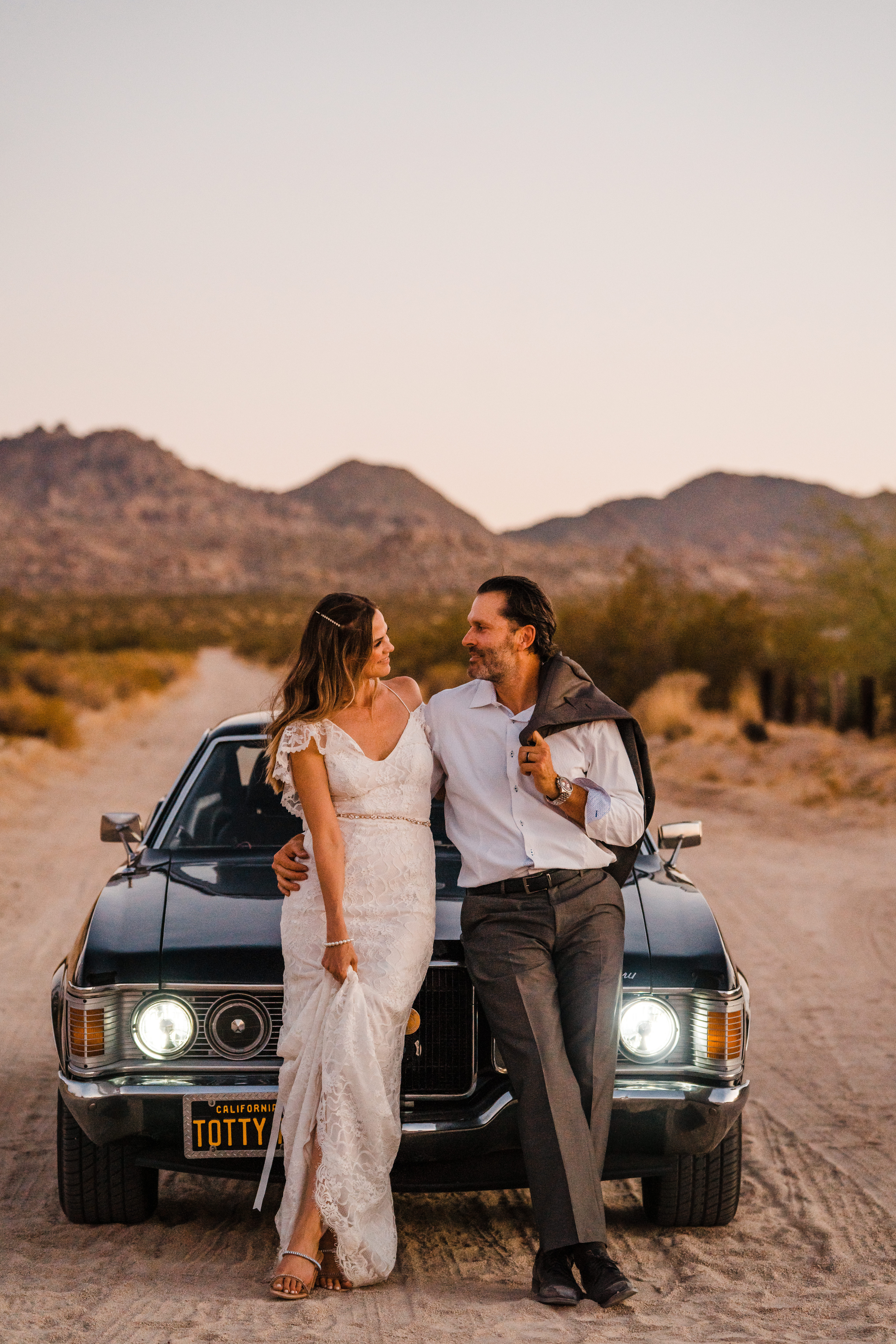 Bride and groom with classic car