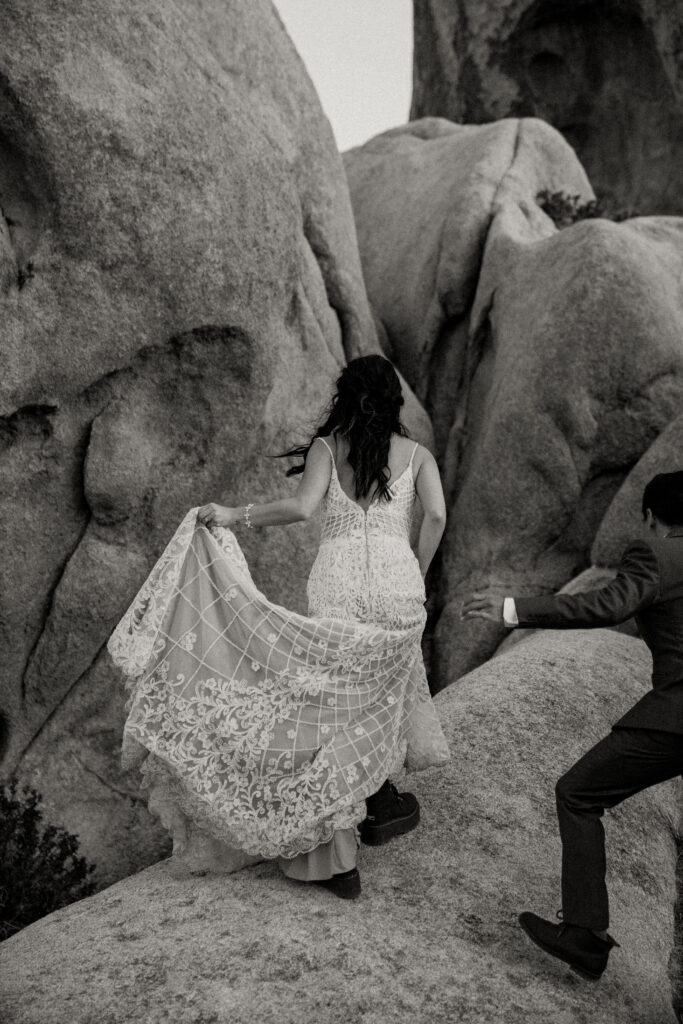 adventurous bride climbing rock in joshua tree national park